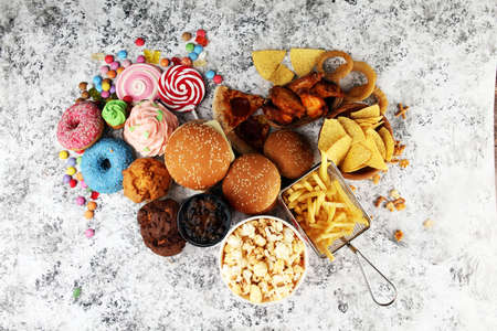 Unhealthy products. food bad for figure, skin, heart and teeth. Assortment of fast carbohydrates food with fries and colaの写真素材