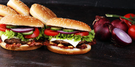 Tasty fresh meat burgers with salad and cheese. Homemade angus burger with salad.