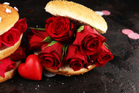 burger for valentines day with red roses and hearts. Festive burger for Valentine's day. Romantic concept for the woman you loveの写真素材