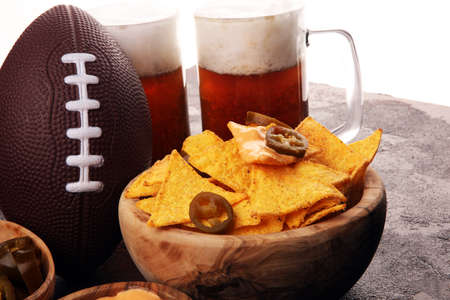 Homemade Nachos with Cheddar Cheese and Jalapenos and beer. Mexican tortilla for football on a table. Great for Bowl Game partyの写真素材