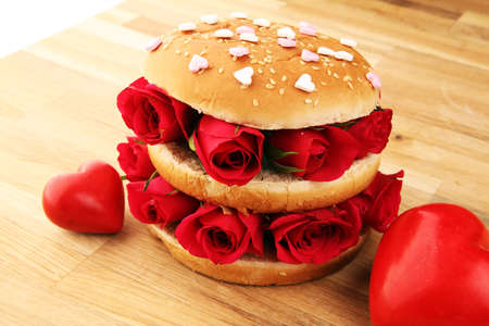 burger for valentines day with red roses and hearts. Festive burger for Valentine's day. Romantic concept for the woman you loveの写真素材