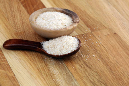 Portion of Psyllium Seeds on rustic background. Psyllium seed husks on woodenの写真素材