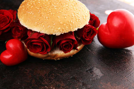burger for valentines day with red roses and hearts. Festive burger for Valentine's day. Romantic concept for the woman you loveの写真素材