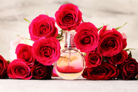 Bottle of perfume with flowers on rustic background. Cosmetic aroma conceptの写真素材