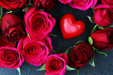 Red roses with hearts on a old table for valentines day conceptの写真素材