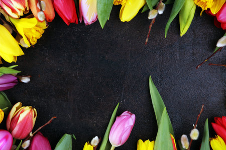 blooming daffodils and easter eggs for spring decoration on rustic background