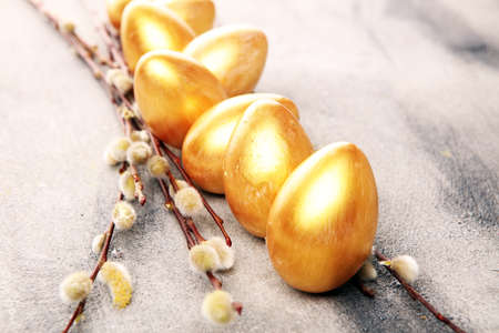 golden easter eggs and pussy willow cats. palm kitten and golden eggs for easter holidayの写真素材