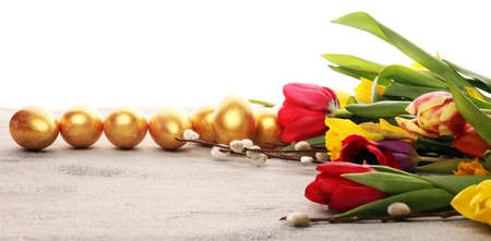 golden easter eggs and pussy willow cats and spring flowerの写真素材