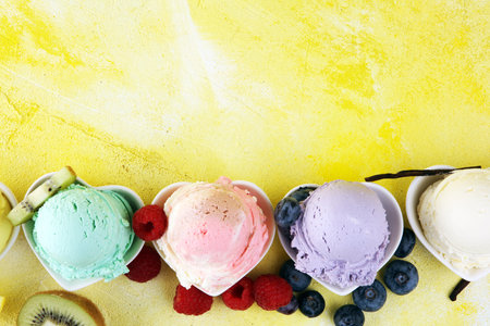 Various of ice cream flavor with fresh blueberry, strawberry, kiwi, lemon, vanilla setup on rustic...