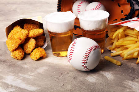 Chicken nuggets and french fries on the table with draft beer. Baseball party food の写真素材
