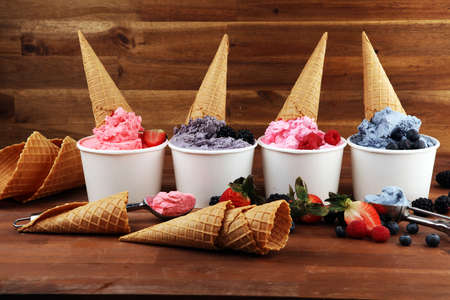 Various of ice cream flavors blueberry, strawberry, blackberry setup on rustic background . Summer and Sweet menu concept. Berries and ice creamの写真素材