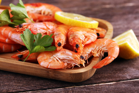 Raw fresh Prawns Langostino Austral. shrimp seafood with lemon and spices on table