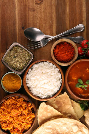 Chicken tikka masala spicy curry meat food in pot with rice and naan bread. indian food with chicken and curryの写真素材