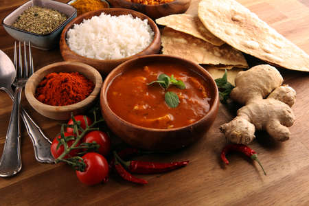 Chicken tikka masala spicy curry meat food in pot with rice and naan bread. indian food with chicken and curryの写真素材