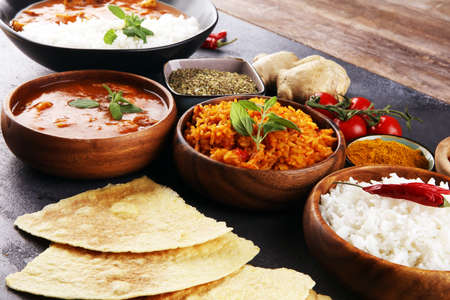 Chicken tikka masala spicy curry meat food in pot with rice and naan bread. indian food with chicken and curryの写真素材