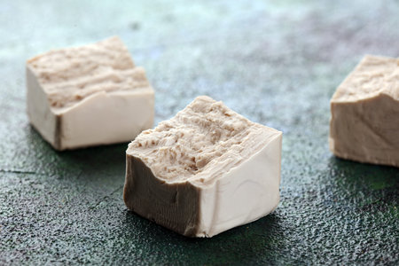 Dry yeast crumbled and yeast block for baking on tableの写真素材