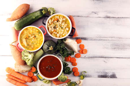 Set of three soups from worldwide cuisines, healthy food. Broth with noodles, beef soup and broth with marrow dumplings. All soups with healthy vegetables.の写真素材