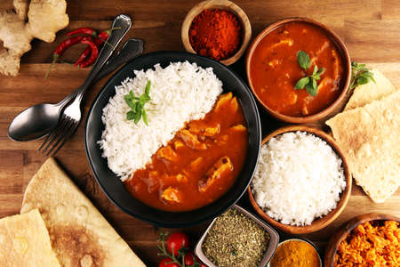 Chicken tikka masala spicy curry meat food in pot with rice and naan bread. indian food with chicken and curryの写真素材
