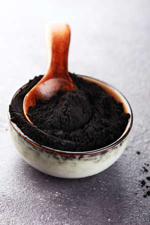 Activated charcoal powder on table for beauty treatmentの写真素材