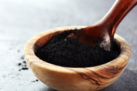 Activated charcoal powder on table for beauty treatmentの写真素材