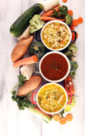 Set of three soups from worldwide cuisines, healthy food. Broth with noodles, beef soup and broth with marrow dumplings. All soups with healthy vegetables.の写真素材