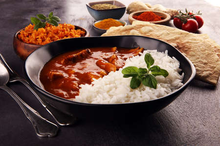 Chicken tikka masala spicy curry meat food in pot with rice and naan bread. indian food with chicken and curryの写真素材