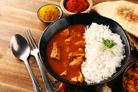 Chicken tikka masala spicy curry meat food in pot with rice and naan bread. indian food with chicken and curryの写真素材