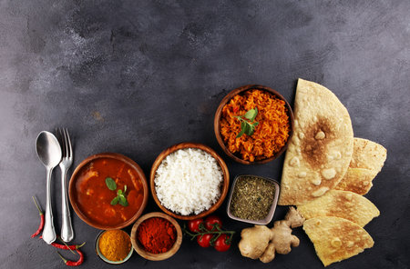 Chicken tikka masala spicy curry meat food in pot with rice and naan bread. indian food with chicken and curryの写真素材