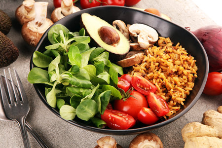 Healthy vegan salad bowl with quinoa, tomatoes, avocado and mixed greens, lettuce. Food and health...