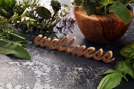 Homegrown and aromatic herbs and wellness letters made of wood. Set of culinary herbs. Green growing sage, oregano, thyme, basil, mint and oregano.