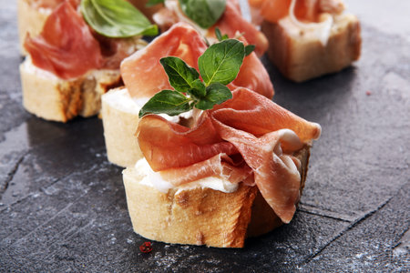 Iberico ham sandwich with homemade bread baked in wood oven or jamon sandwich with fresh herbs