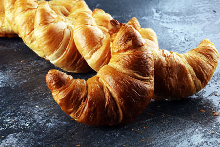 freshly baked croissants on rustic board, bakery breakfast conceptの写真素材