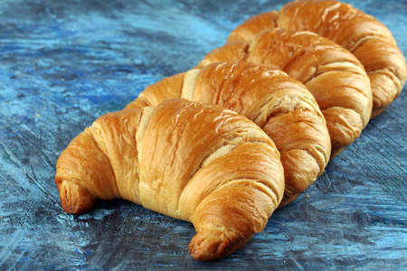 freshly baked croissants on rustic board, bakery breakfast conceptの写真素材