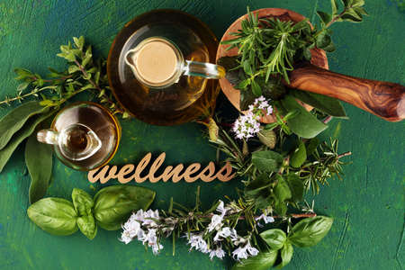 Homegrown and aromatic herbs and wellness letters made of wood. Set of culinary herbs. Green growing sage, oregano, thyme, basil, mint and oregano.の写真素材