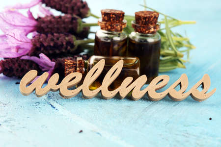 lavender herbal oil and lavender flowers. bottle of lavender massage oil for aromatherapy beauty treatment and wellness letters made of woodの写真素材