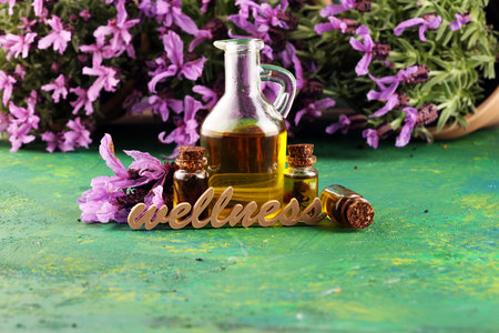lavender herbal oil and lavender flowers. bottle of lavender massage oil for aromatherapy beauty...