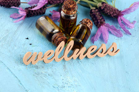 lavender herbal oil and lavender flowers. bottle of lavender massage oil for aromatherapy beauty treatment and wellness letters made of woodの写真素材
