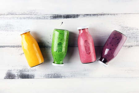 Assortment of fruit smoothies in glass bottles. Fresh organic Smoothie ingredients. Smoothies for health or detox diet food concept.の写真素材