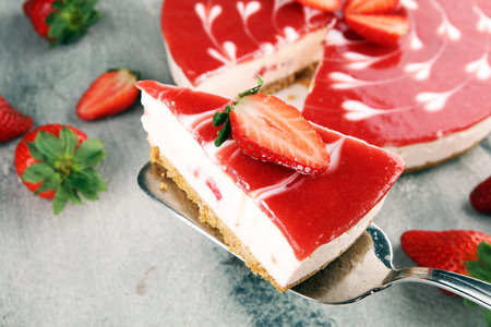 Delicious strawberry cheesecake with berries on stone table