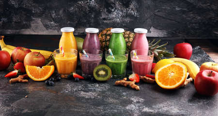 Assortment of fruit smoothies in glass bottles. Fresh organic Smoothie ingredients. Smoothies for health or detox diet food concept.の写真素材