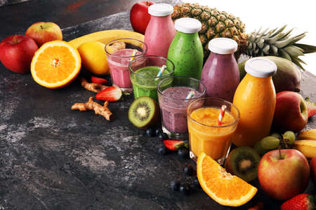 Assortment of fruit smoothies in glass bottles. Fresh organic Smoothie ingredients. Smoothies for health or detox diet food concept.の写真素材