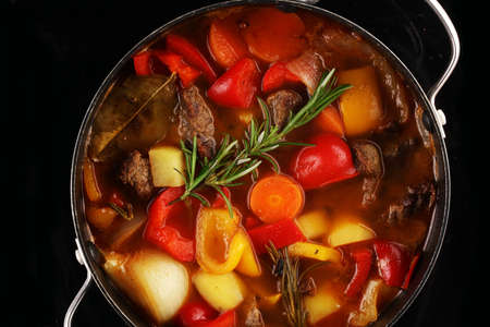 Meat stew with vegetables. Beef stew with potatoes, carrots and herbs on table. の写真素材