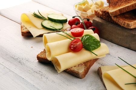 canape with yellow cheese and tomato. bread or toast with cheese for breakfastの写真素材