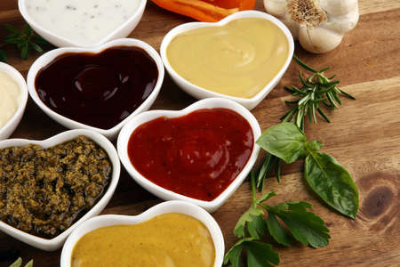 Sauces Assortment. Set of various sauces in bowls with ketchup, mayonnaise, pesto and mustardの写真素材
