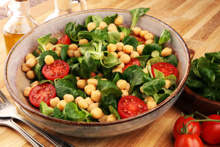 chickpea salad with ingredient and tomatoes and lambÂ´s lettuce. healthy foodの写真素材