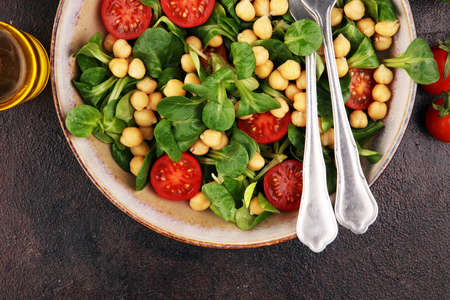 chickpea salad with ingredient and tomatoes and lambÂ´s lettuce. healthy foodの写真素材