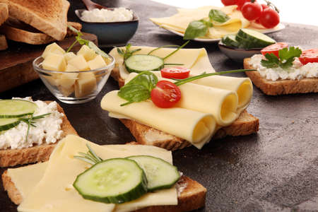 canape with yellow cheese or cream cheese and tomato. bread or toast with cheese for breakfastの写真素材
