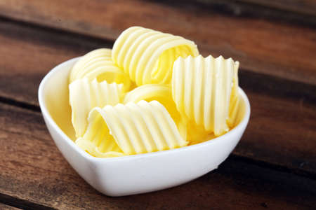 butter swirls. margarine or spread, fatty natural dairy product. High-calorie food for cooking and eatingの写真素材
