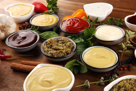 Sauces Assortment. Set of various sauces in bowls with ketchup, mayonnaise, pesto and mustardの写真素材