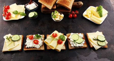 canape with yellow cheese or cream cheese and tomato. bread or toast with cheese for breakfastの写真素材
